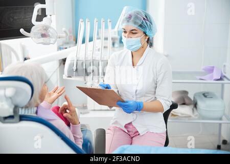 Joyful dental worker recording the patient story Stock Photo