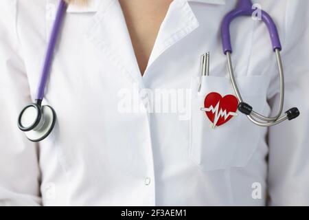 Brooch in shape of heart hanging on uniform of doctor closeup