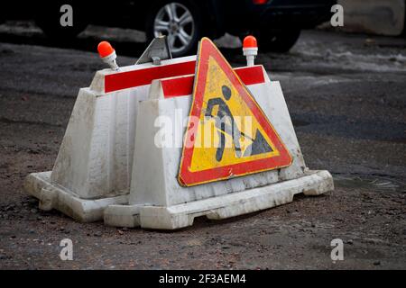 Triangular road sign undergoes repairs. High quality photo Stock Photo