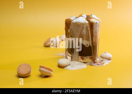 coffee drink with delicate jam and flowing foam on a yellow background Stock Photo