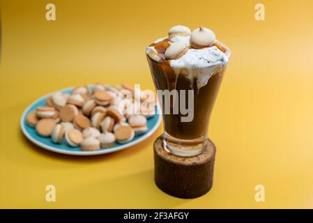 coffee drink with delicate jam and flowing foam on a yellow background Stock Photo