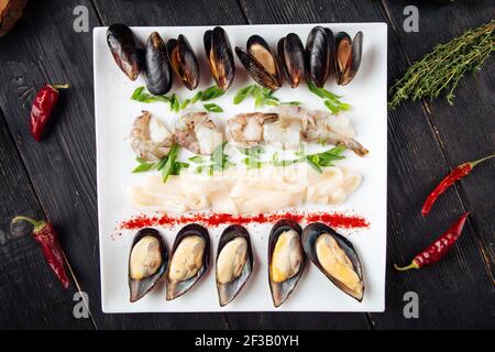 Assorted seafood platter on the dark wooden table Stock Photo