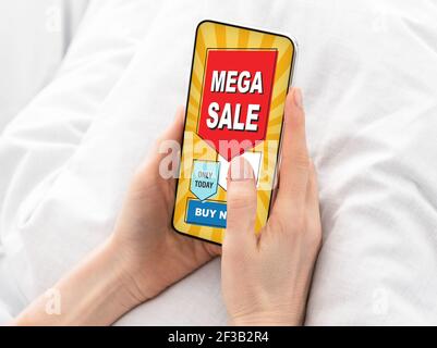 Closeup of feman hands holding smartphone with shopping mobile application Stock Photo