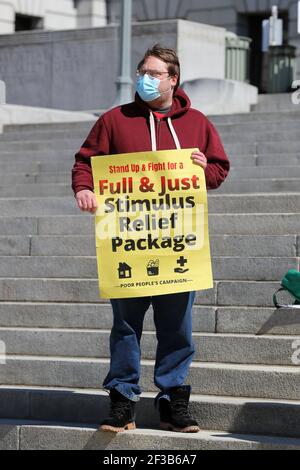 Harrisburg, United States. 15th Mar, 2021. A man holds a sign at the Pennsylvania State Capitol during a PA Poor People's Campaign press conference in Harrisburg, Pennsylvania on March 15, 2021. (Photo by Paul Weaver/Sipa USA) Credit: Sipa USA/Alamy Live News Stock Photo