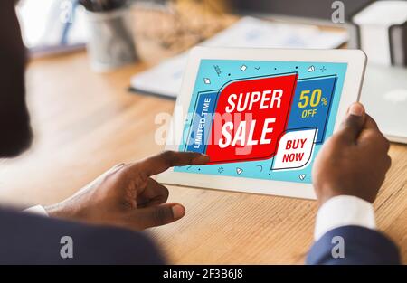 Cropped image of businessman touching digital tablet screen, shopping online Stock Photo