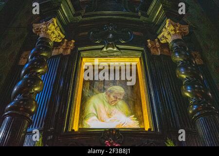 Pope John Paul II artwork in swirling Art Nouveau framing, lit from below; in the Basilica of St Francis, Krakow, Poland Stock Photo