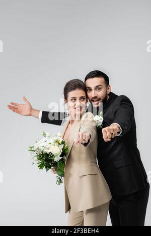 Wedding rings and flowers isolated on white background Stock Photo - Alamy