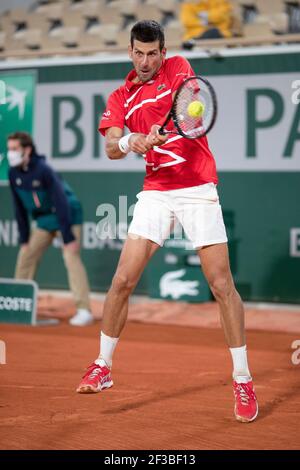 Serbian tennis player Novak Djokovic playing a backhand return during French Open 2020, Paris, France, Europe. Stock Photo