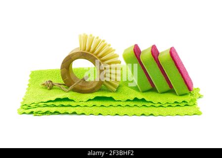 Multicolored cleaning sponges and dish brushes on microfiber cloth isolated on a white background. House cleaning supplies Stock Photo