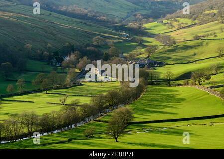 Picturesque Dales village (cottages & farms) & River Wharfe, nestling by hills & hillsides in steep-sided valley - Hubberholme, Yorkshire, England, UK