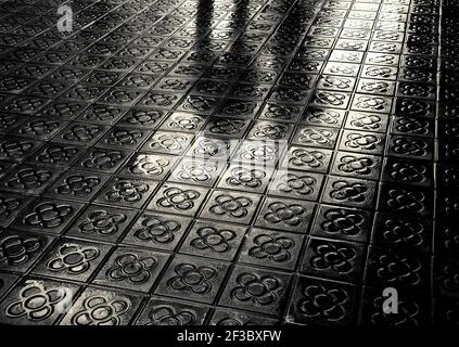 Barcelona. Silhouette of couple reflected on wet flower street paving. Romantic vacation background. Black and white photo. Stock Photo