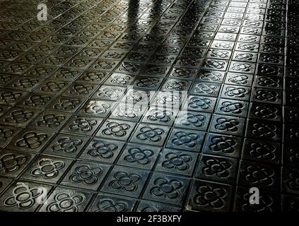 Barcelona. Silhouette of couple reflected on wet flower street paving. Romantic vacation background. Stock Photo