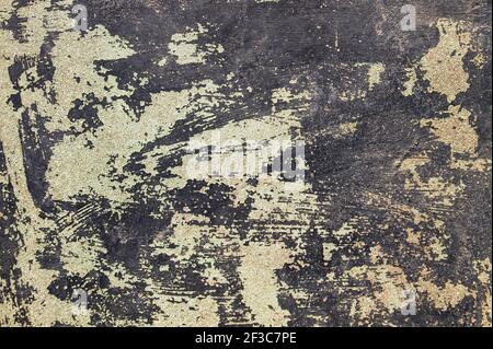 Old worn wall with black peeling paint, grunge background or texture Stock Photo