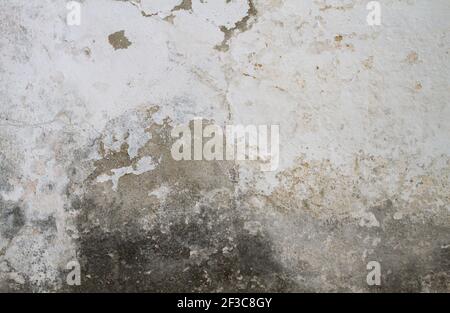 Old concrete wall with white peeling paint, grunge background or texture Stock Photo