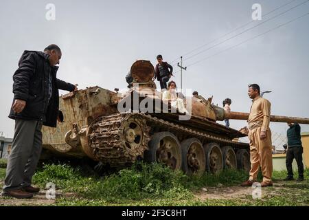 Halabja, Iraq. 16th Mar, 2021. People visiting the Halabja Monument inspect a military vehicle that was used in the chemical attack carried out by the Iraqi government on 16 March 1988 during the closing days of the Iran·Iraq War in the Kurdish city of Halabja, which killed nearly 5000 people and injured about 10000, most of them were civilians. Credit: Ismael Adnan/dpa/Alamy Live News Stock Photo