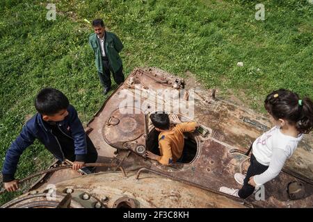 Halabja, Iraq. 16th Mar, 2021. Children visiting the Halabja Monument play on the top of a military vehicle that was used in the chemical attack carried out by the Iraqi government on 16 March 1988 during the closing days of the Iran·Iraq War in the Kurdish city of Halabja, which killed nearly 5000 people and injured about 10000, most of them were civilians. Credit: Ismael Adnan/dpa/Alamy Live News Stock Photo