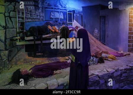 Halabja, Iraq. 16th Mar, 2021. A visitor of the Halabja Monument looks at a re-enactment scene of people who died in the chemical attack carried out by the Iraqi government on 16 March 1988 during the closing days of the Iran·Iraq War in the Kurdish city of Halabja, which killed nearly 5000 people and injured about 10000, most of them were civilians. Credit: Ismael Adnan/dpa/Alamy Live News Stock Photo