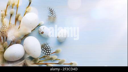 Flat lay Easter composition with a willow branch and eggs on a blue background Stock Photo