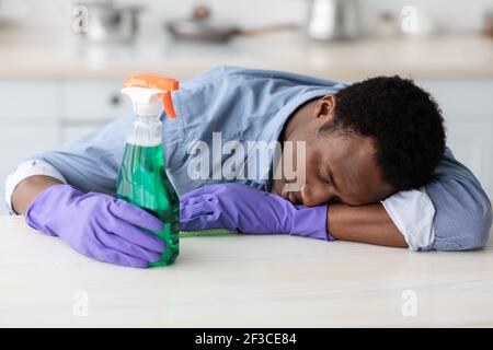 https://l450v.alamy.com/450v/2f3ce84/tired-black-guy-in-gloves-holding-spray-bottle-fell-asleep-2f3ce84.jpg