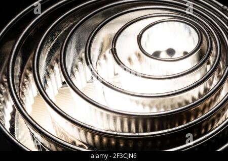 Metal rings starting from the lower left side as life circles backlit Stock Photo