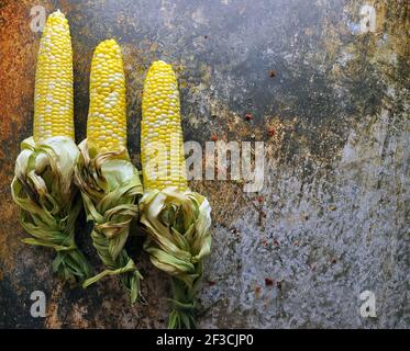 Golden Cooked Corn on a Dark Background with Spices.Top View,copy space for text. Stock Photo
