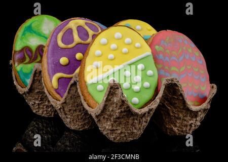 Easter decorated baked eggs, cookies on a black background Stock Photo