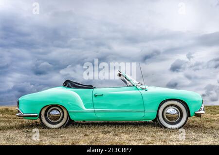 BOSSCHENHOOFD, NETHERLANDS - Feb 06, 2021: BOSSCHENHOOFD/NETHERLANDS-JUNE 11, 2018: side view of a mint green classic volkswagen kamann ghia convertib Stock Photo