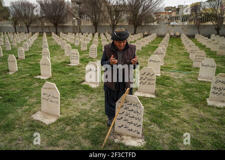 Halabja, Iraq. 16th Mar, 2021. A man visits the grave of his lost ones at Halabja Cemetery on the 33rd anniversary of Halabja chemical attack, which killed nearly 5000 people and injured about 10000, most of them were civilians. Credit: Ismael Adnan/dpa/Alamy Live News Stock Photo