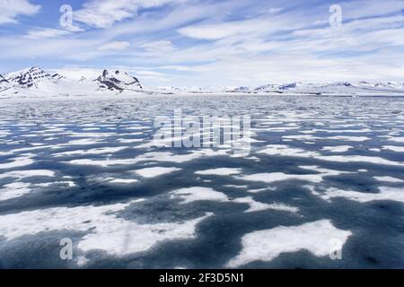 Iceberg and mountainous landscape - Late SpringSvalbard (Spitsbergen) Norway LA003654 Stock Photo