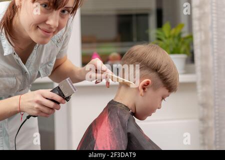 Mom Makes a Haircut for Her Two Year Old Son with Scissors in the Bathroom  at Home Stock Image - Image of casual, scissors: 182291571