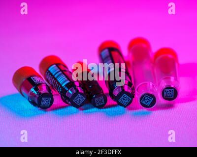 An assortment of jacketed and non-jacketed 2D barcoded biological sample tubes. Stock Photo