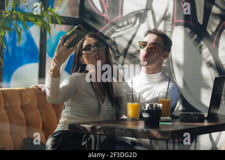 Co-workers spending time together on a break while working on a project on a lovely sunny day. Stock Photo