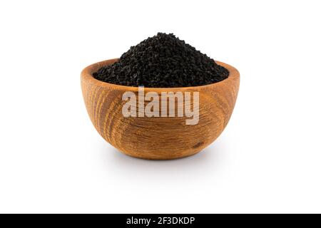 Black cumin isolated on white background. Black cumin seed in wooden bowl isolated on white background. Seeds with copy space for text. A pile of nige Stock Photo