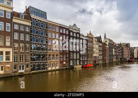 Houses on the Damrak in Amsterdam in Holland, Netherlands Stock Photo