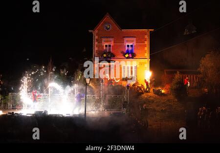 two male performers in santa dress on stage with silver fireworks in Saint quirin Stock Photo