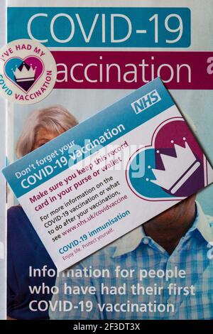 Covid-19 Vaccination information leaflet from NHS with I've had my Covid vaccination sticker & vaccination record card Stock Photo