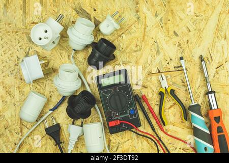 Electrical lamp holders and electrical appliances. Power tools on the table with space for text. Various electrical tools on a wooden table Stock Photo