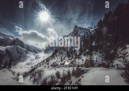 Malaiesti chalet in winter. Beautiful view of Malaesti valley in Bucegi mountains, Carpathians Alps, Romania Stock Photo