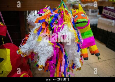 Colorful paper pinatas hanging inside a Mexican market Stock Photo