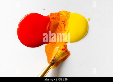 Red and Yellow Paint Making Orange Stock Photo