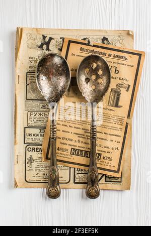 Vintage spoons. Old newspaper on white background Stock Photo