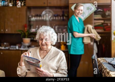 Friendly nurse supporting an elderly lady Stock Photo