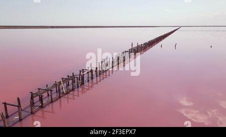 Aerial view of wooden structures for collecting salt on a pink lake, Genichesk Stock Photo