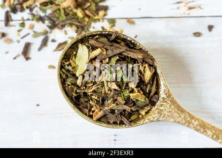 Loose green tea blend and a pretty gold spoon. Stock Photo
