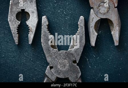Old combination used pliers close-up, vintage styling, industry Stock Photo