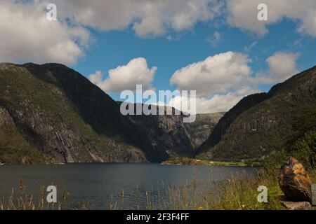 Beautiful ladscape on the mountains lake surrounded by mountains. Huge lake in Norway. Blue Scandinavian sky. Stock Photo