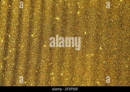 rough golden surface with glints of light. texture background Stock Photo