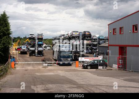 Cars stacked up in a breakers yard Stock Photo