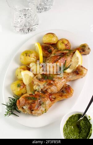 Tasty roasted chicken legs with potatoes. Directly above. Stock Photo
