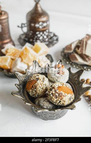 bowl with various pieces of Turkish delight and Oriental sweets on a light background. Stock Photo